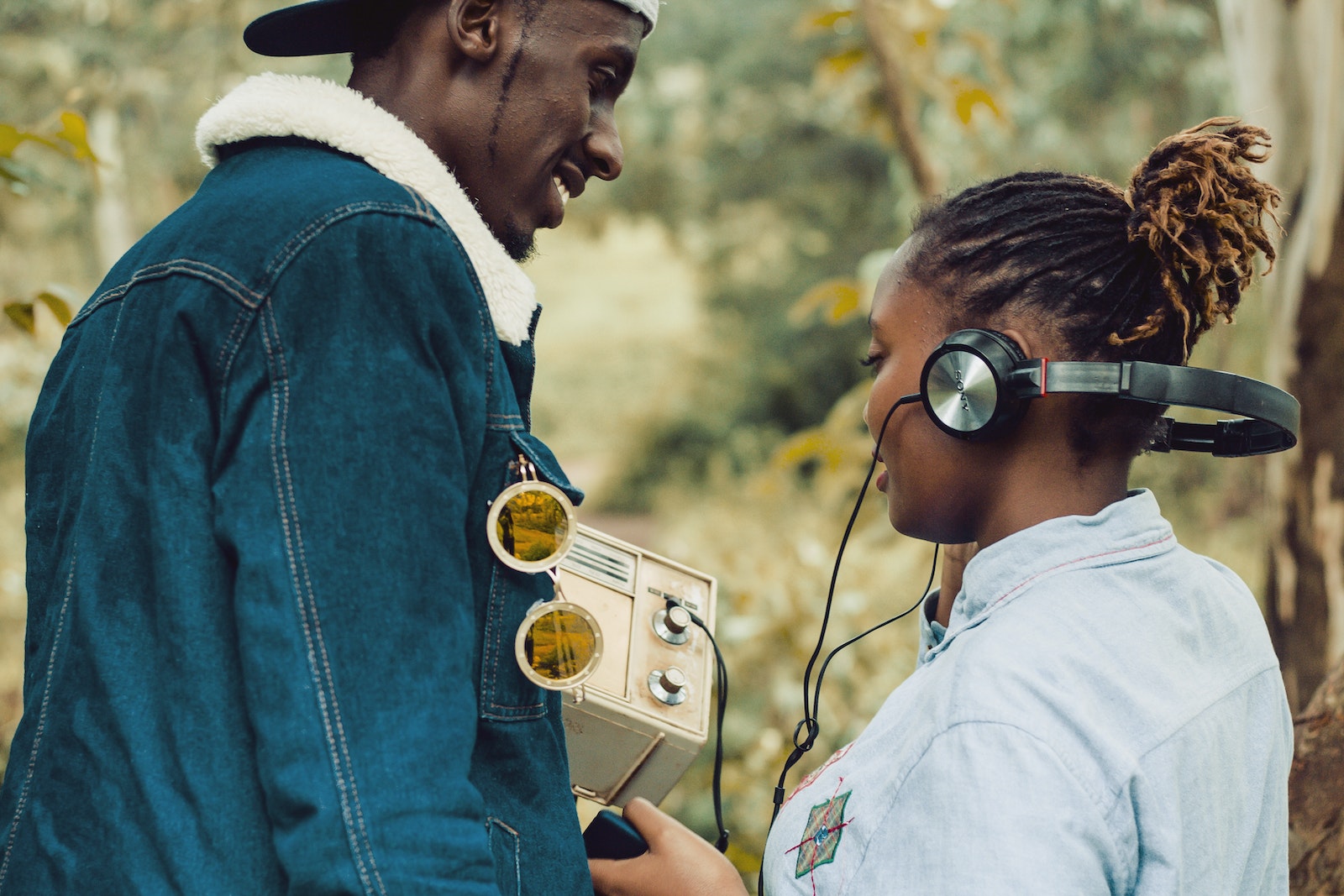 Woman Wearing Headphones Standing Beside Man