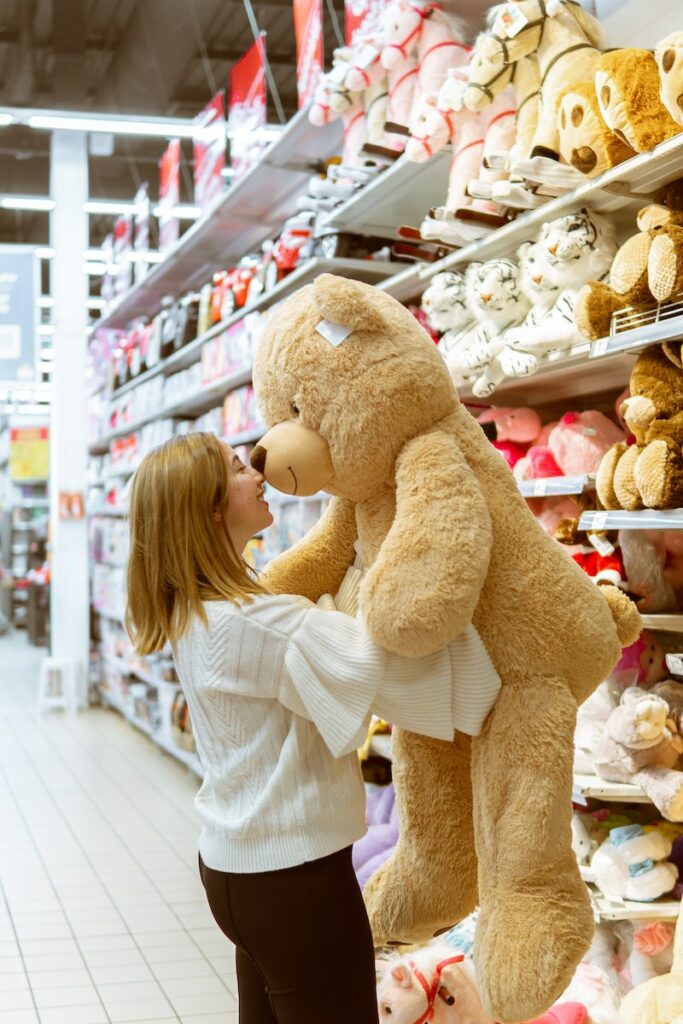 Woman Carrying Bear Plush Toy Inside Store